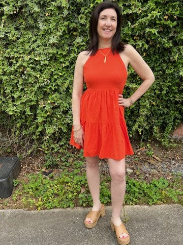 <p>This spicy orange halter dress, with a tiered skirt and convenient side pockets, is perfect for any fun and vibrant occasion. Lined for comfort, pair it with a cute jacket for an extra touch of style.</p> <p>Material: 100% Cotton; Lining: 100% Polyester</p> <p>Care Instructions: Hand wash cold, line dry</p>