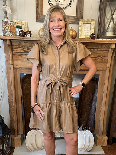 Look your best in this Tan Faux Leather Dress! With a snap button up front, collared neck, and tie waist, this dress is perfect for any occasion. Its tiered skirt, pleated bell sleeves and tan faux leather will make sure you stand out! Pair with statement heels for such a cute look!  Material: 50% Polyurethane Leather / 47% Polyester / 3% Spandex  Care Instructions: Hand wash in cold water, line dry