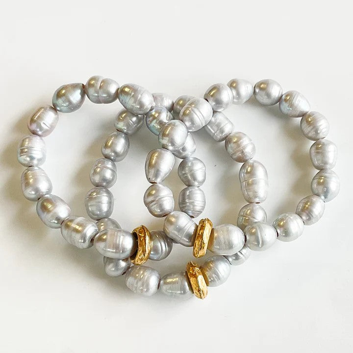 Experience the elegance and beauty of our Pearl Washer Bracelet. This lovely piece features freshwater pearls and a brass spacer, creating a stunning stretch bracelet. Wear it alone for a delicate touch or stack it for a bold statement. 
