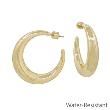 Discover the perfect foundation for your jewelry wardrobe with these elegant gold rounded hoop earrings. Built with water-resistant technology, they withstand moisture and daily wear while maintaining their brilliant shine. The reliable post-back design offers secure, comfortable wear from morning to night. These versatile hoops work with any outfit and occasion, making them the indispensable staple every collection deserves.

Size: 2" Hoop