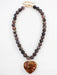 Discover the perfect blend of natural beauty and heartfelt style with this exquisite dark brown beaded necklace. Handcrafted with warm, earthy beads and anchored by a breathtaking natural stone heart pendant, this piece radiates understated elegance. The rich brown tones create a versatile foundation that pairs effortlessly with any outfit, while the meaningful heart centerpiece adds a personal touch of sophistication.

Chain length: 16-18"