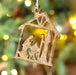 Bring traditional meaning into your home with this beautifully carved wooden nativity ornament. With it's bronze sheen and careful craftsmanship, this ornament will remind you of the holiday season year round. Give your home the gift of tradition this year!  Approximate size: 4.5" x 6" x .75"