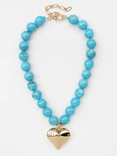 Warm turquoise beads create understated elegance, while a delicate heart charm adds a touch of sentiment. The 18 mm beads catch light beautifully, making this necklace ideal for layering or solo wear. Effortlessly versatile—perfect for everyday moments and special occasions alike. A timeless piece that complements any style.
