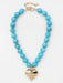 Warm turquoise beads create understated elegance, while a delicate heart charm adds a touch of sentiment. The 18 mm beads catch light beautifully, making this necklace ideal for layering or solo wear. Effortlessly versatile—perfect for everyday moments and special occasions alike. A timeless piece that complements any style.