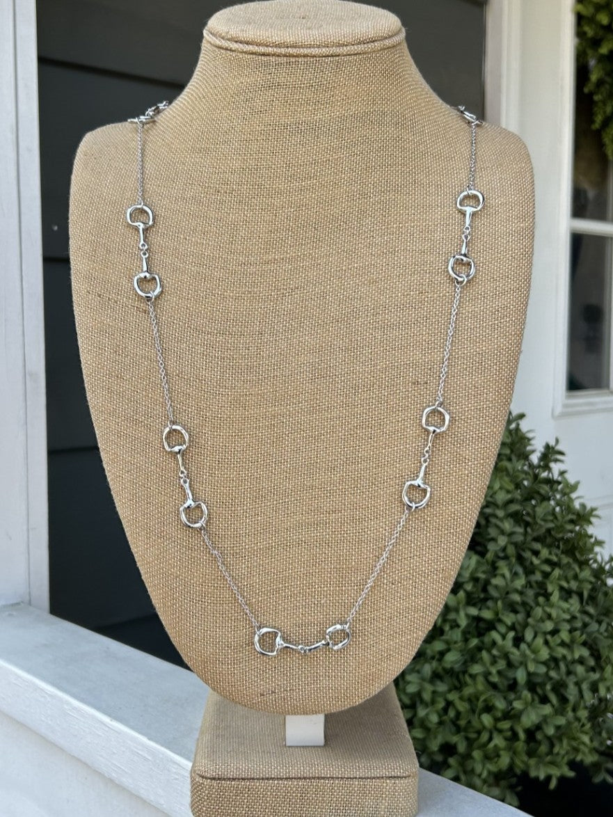 Elegant long necklace featuring delicate silver chain adorned with charming equestrian boot accents. A sophisticated choice for horse enthusiasts who appreciate distinctive jewelry with meaningful detail. The extended length offers versatile styling options, whether worn layered or as a standalone statement piece. Perfect for adding a touch of equestrian elegance to any wardrobe.

Approximate Length: 34-36"

Note: Silver N' Accessories jewelry is brass and stainless steel with rhodium and 18 KT gold plated.