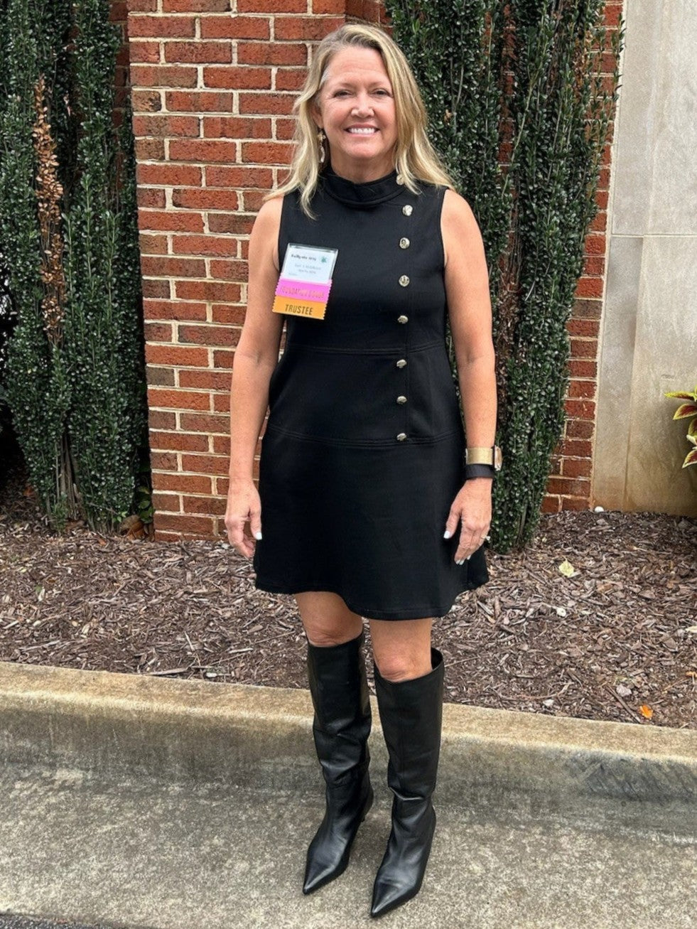 This black sleeveless dress is so flattering. It accentuates your waste without being fitted, has fabulous gold button buttons up the left side and even has hidden pockets! We love the fabric and mock neck, too.&nbsp;

Wear it sleeveless early in the season then add a blouse our simple shirt under it in cooler weather. Of course, it will look great with a jacket, too.&nbsp;

Material: 52% Polyester / 45% Cotton / 3% Spandex

Care Instructions: Gentle cool hand wash, dry flat