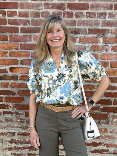 Discover effortless elegance with this enchanting puffed sleeve top. Set against a soft cream canvas, vibrant blue and green florals create a fresh, botanical aesthetic that feels both timeless and contemporary. The signature puffed sleeves bring romantic dimension, while carefully placed vertical accent stitching adds sophisticated detail and flattering structure. Whether you're dressing for brunch, work, or weekend adventures, this lovely piece transitions seamlessly through your day.

Material: 100% Cott