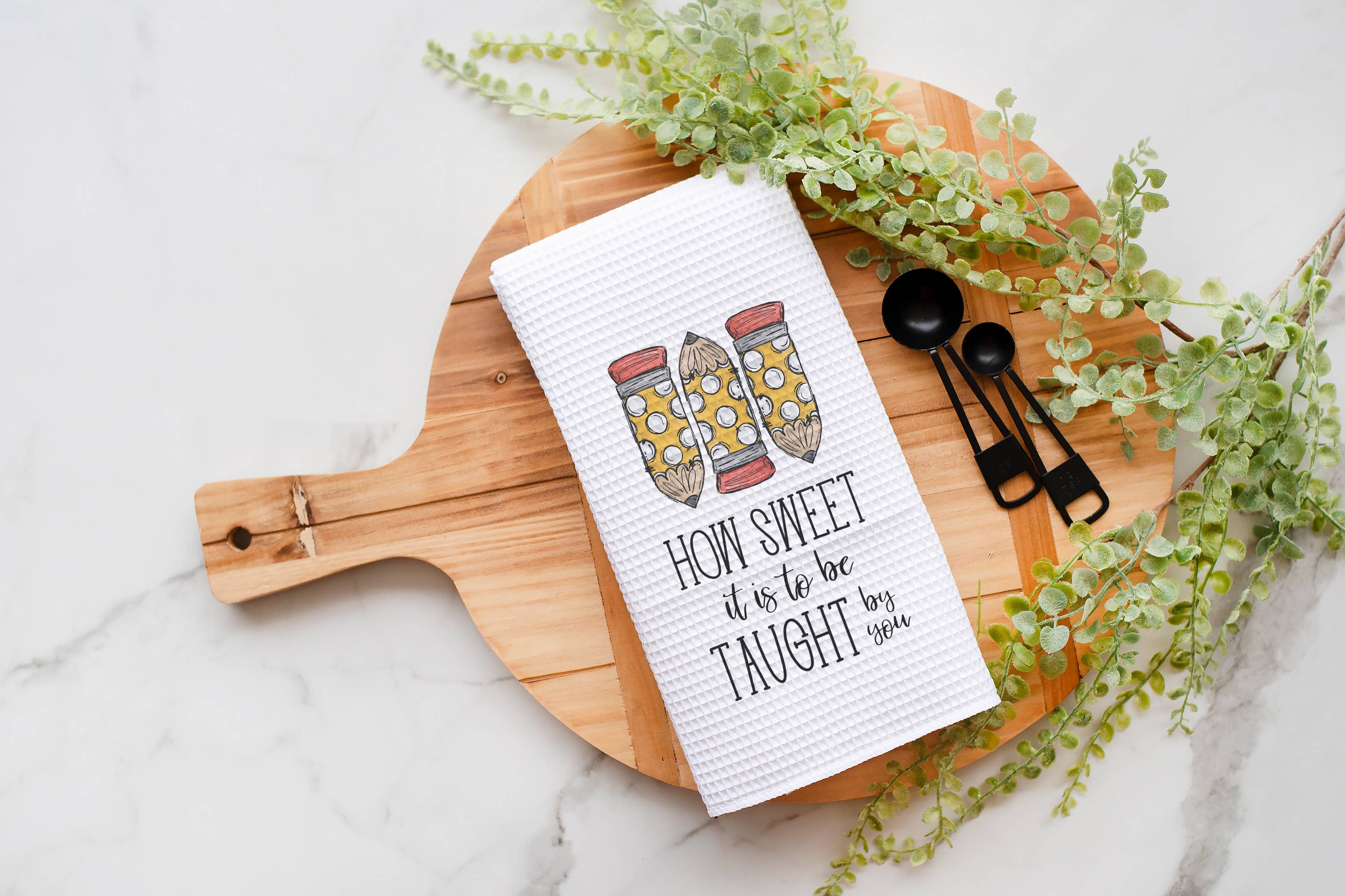 This Pencil Trio Teacher Tea Towel is the perfect addition to both classroom and kitchen decor. Made with a waffle weave, it provides exceptional drying power while remaining lint-free, making it ideal for glass and delicate surfaces. Thoughtfully designed as a great back-to-school gift, it combines style and functionality to brighten any teacher’s day.

Size: 16" x 24"

Material: 80% Polyester / 20% Polyamide