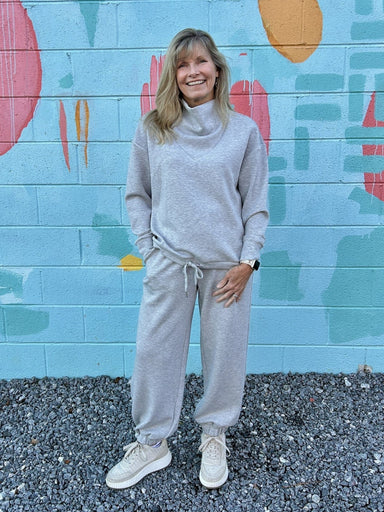 Experience ultimate comfort with this Heather Gray Cowl Neck Sweatshirt. Crafted from irresistibly soft material, it’s perfect for cozy days. The adjustable drawstring bottom allows you to cinch the fit for added warmth and style. Whether lounging or out and about, this sweatshirt combines casual ease with a flattering silhouette you'll love.

Pair with our matching "Jogger Pants".

Paula is wearing a size Medium.

Material: 48% Modal / 48% Polyester / 4% Spandex

Care Instructions: Hand wash separately in 