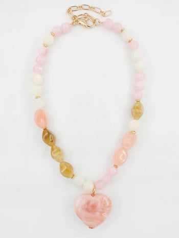 Make a heartfelt statement with this enchanting beaded necklace, showcasing a gorgeous pink heart pendant surrounded by a harmonious palette of pink, cream, and gray beads. This versatile piece is your go-to accessory for Valentine's Day romance, spring refreshes, or timeless everyday elegance.&nbsp;

Length: 16-18"