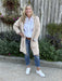Stay warm and cozy while looking your best in this Front Pocket Knit Cardigan. Crafted with long sleeves and soft fabric, this beige cardigan keeps you comfy all day. Front pockets help to provide extra warmth on those colder days. Enjoy enduring comfort and style with this cardigan!  Material: 100% Polyester Microfiber  Care Instructions: Machine wash cold, lay flat to dry or tumble dry low