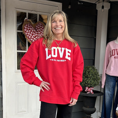 Carolee is wearing a red 'LOVE is all you need' sweatshirt
