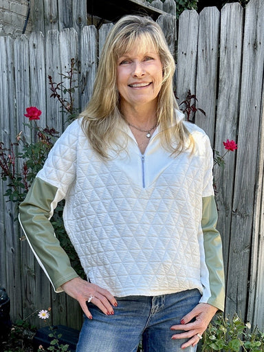 We love this unique quilted half zip top with it's fun vegan leather sleeve accent!&nbsp; THML is the master of creating great style by combining unique textiles and fabrics. It;s a nice, medium to light weight and perfect for fall in the south.&nbsp;&nbsp;

Carolee is wearing a small.

Material: 98% Polyester / 2% Spandex

Care Instructions: Gentle cool hand wash, dry flat