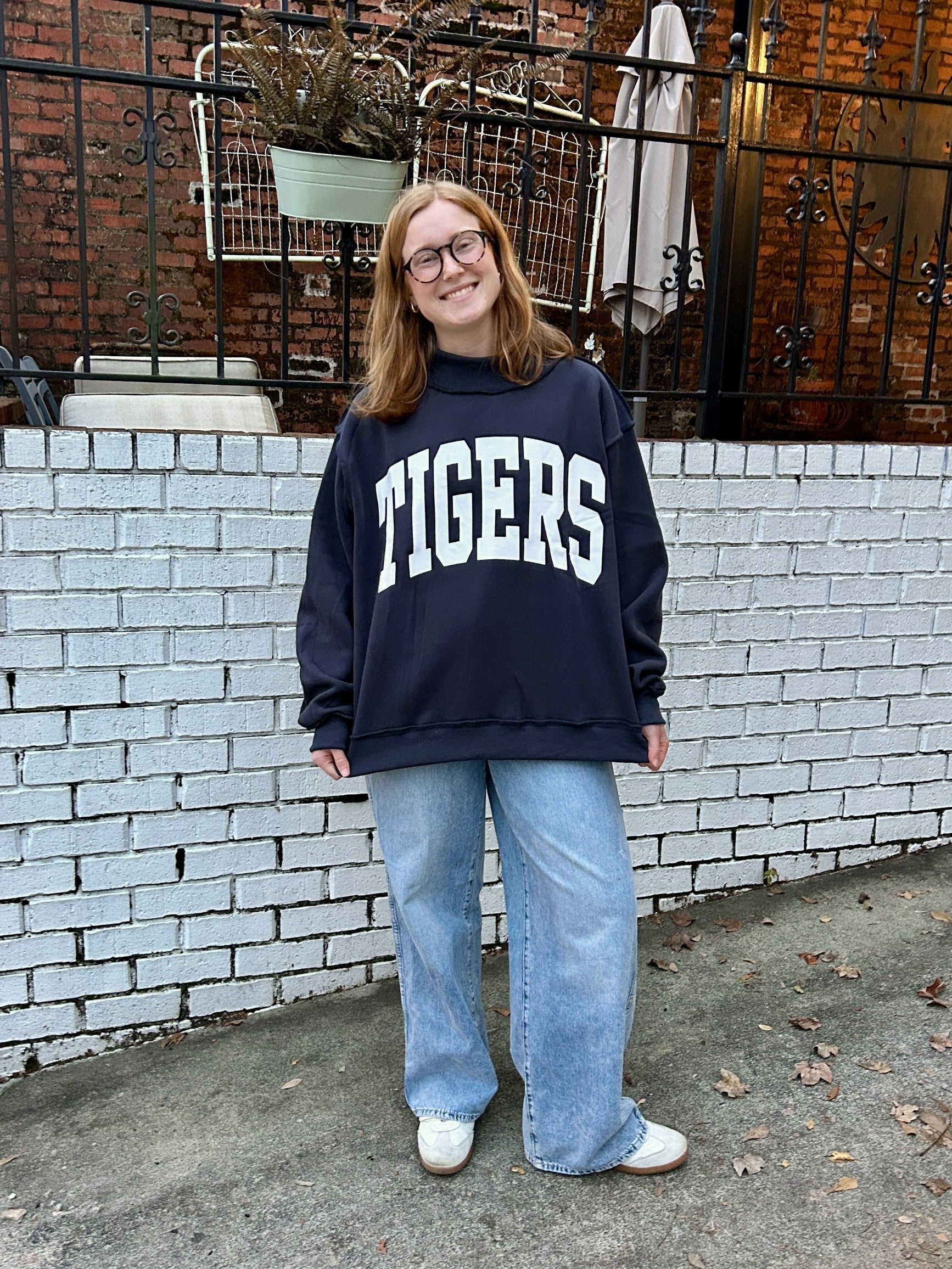 Flip between two iconic looks with this reversible sweatshirt featuring "TIGERS" on one side and "WAR DAMN" on the other—perfect for sharing your Auburn pride in style! Crafted from the softest cozy fleece, this oversized sweatshirt delivers comfort that feels like a warm embrace. The drop shoulder silhouette and long sleeves create an effortlessly relaxed vibe, while rib-banded cuffs and hemline keep everything in place. One sweatshirt, endless styling possibilities.

Sizes are Small/Medium and Large/XLarg