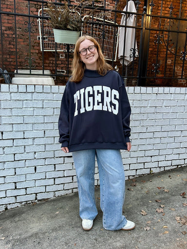Flip between two iconic looks with this reversible sweatshirt featuring "TIGERS" on one side and "WAR DAMN" on the other—perfect for sharing your Auburn pride in style! Crafted from the softest cozy fleece, this oversized sweatshirt delivers comfort that feels like a warm embrace. The drop shoulder silhouette and long sleeves create an effortlessly relaxed vibe, while rib-banded cuffs and hemline keep everything in place. One sweatshirt, endless styling possibilities.

Sizes are Small/Medium and Large/XLarg
