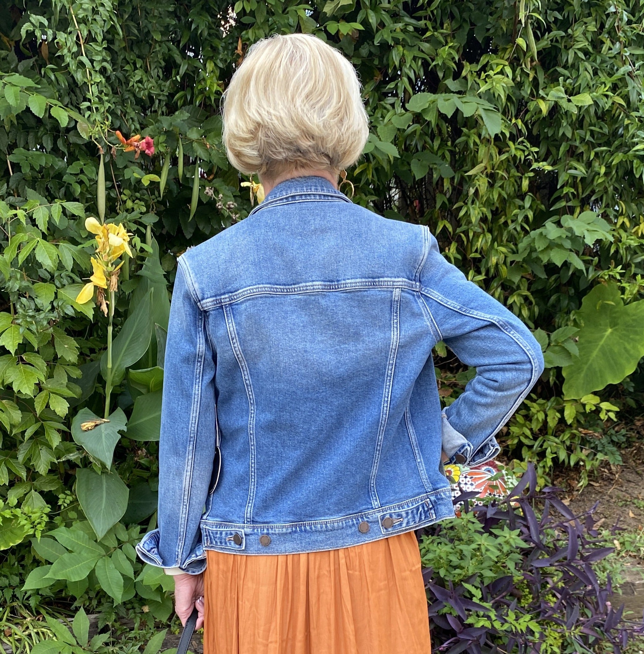 The back of the denim jacket has great stitching detail, and shows the feminine fit. 