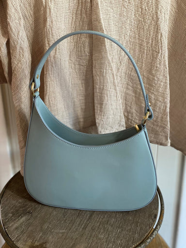 This beautifully structured bag is chic and genuine Italian leather. It has a beautiful silhouette with a hand strap that can also fit over your shoulder.   Details:   Top zipper Detachable cross body strap 11.5 x 7 inches Inside zipper pocket