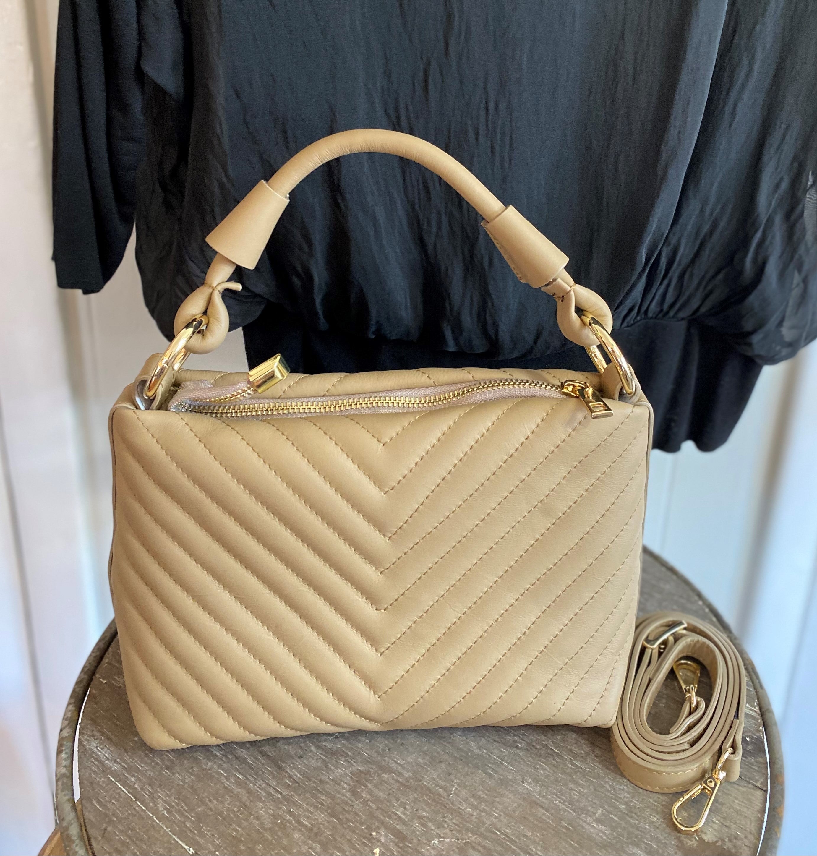 This beautiful Italian leather bag is detailed with timeless quilted stitching. It has luxe metal hardware and a removable shoulder strap.  Details: Supple genuine Italian quilted stitched leather. Top zipper. Attached inside pocket. Approximately 11" x 7.25" x 4"
