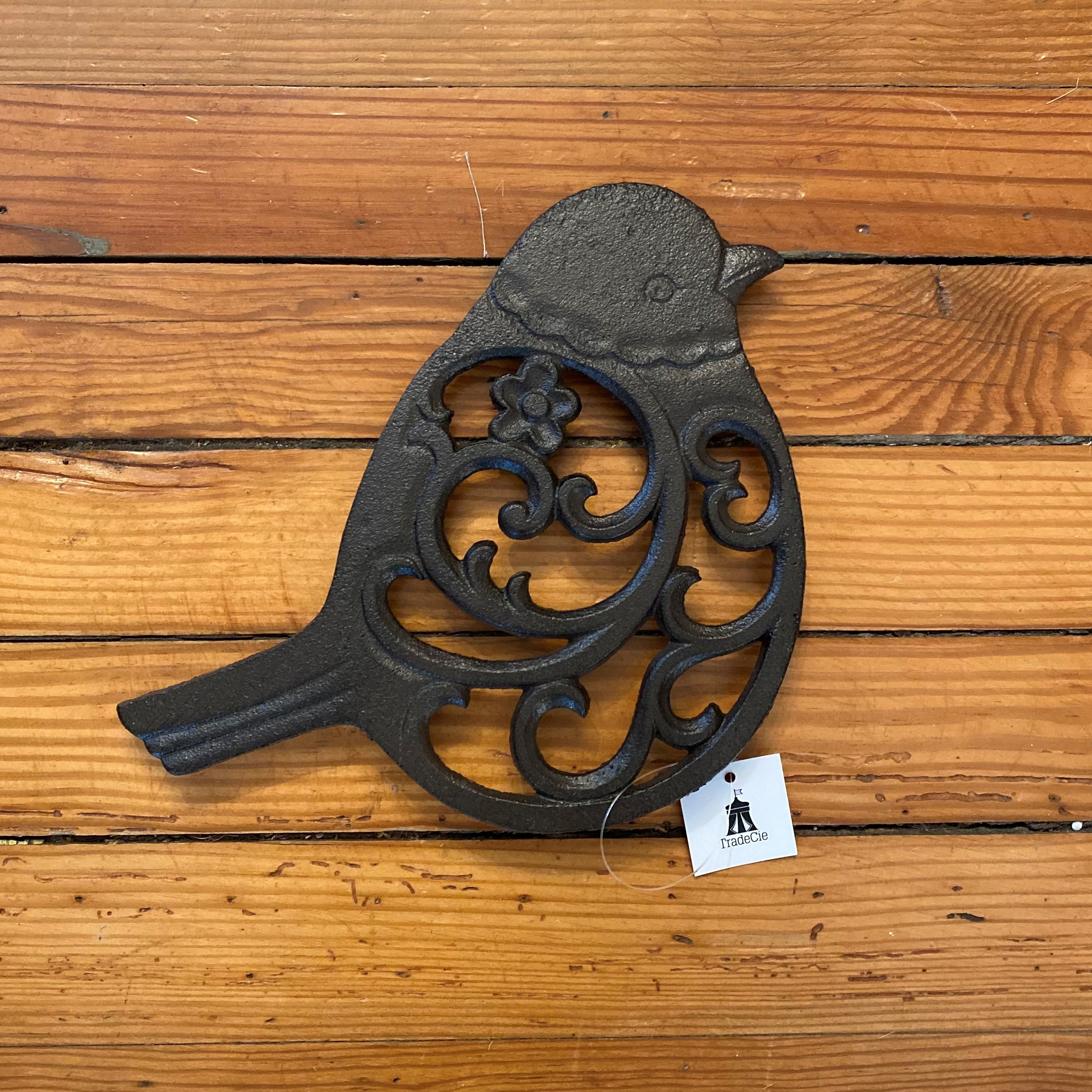 This is such a nice trivet and great for the spring or any time of year! It's in the shape of a bird with a flower and swirl. It's cast iron and the approximate dimensions are 8" x 7" x .5".