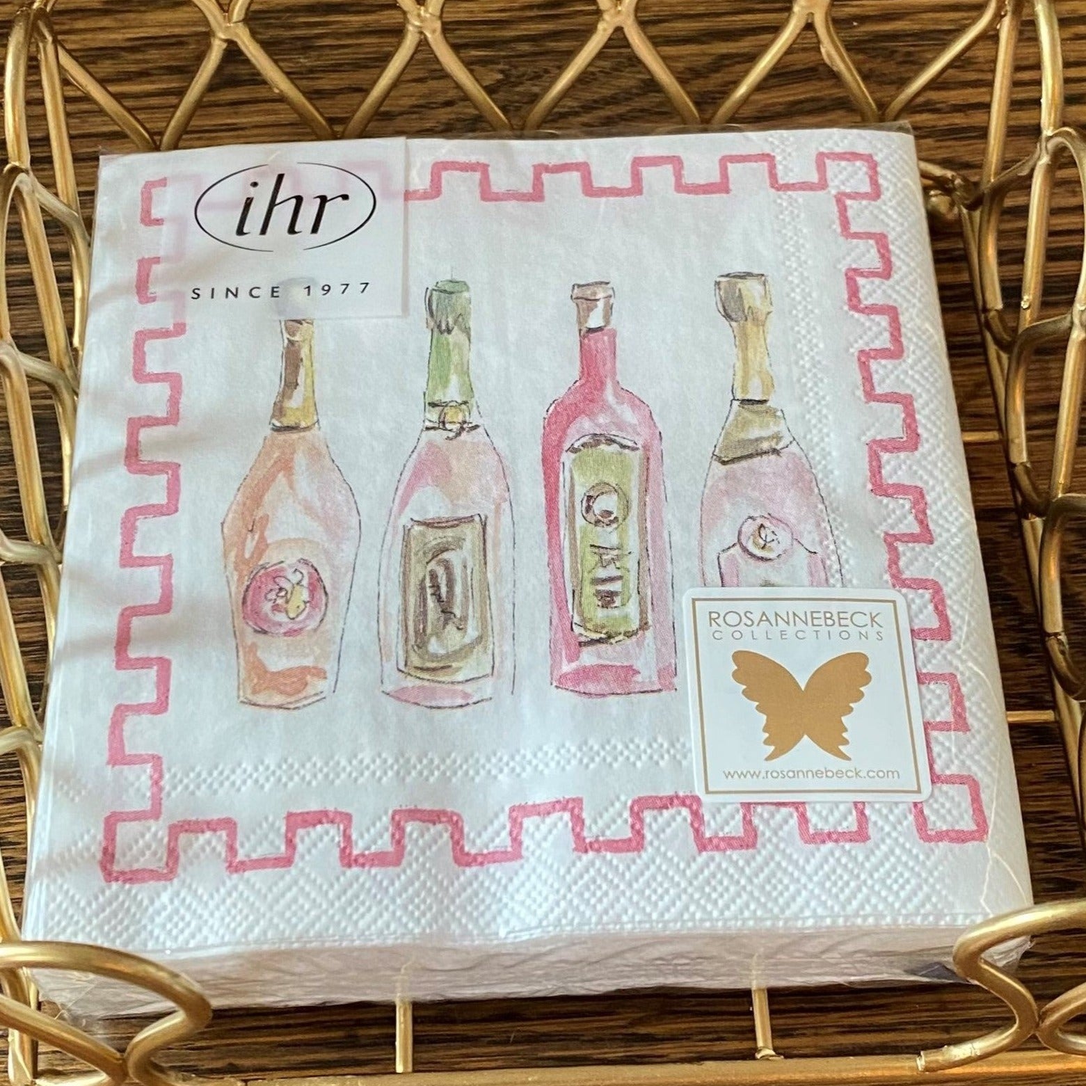 Bubbly themed cocktail napkins featuring 4 pretty bottles in pinks and pale green and a pink bric-a-brac border. 