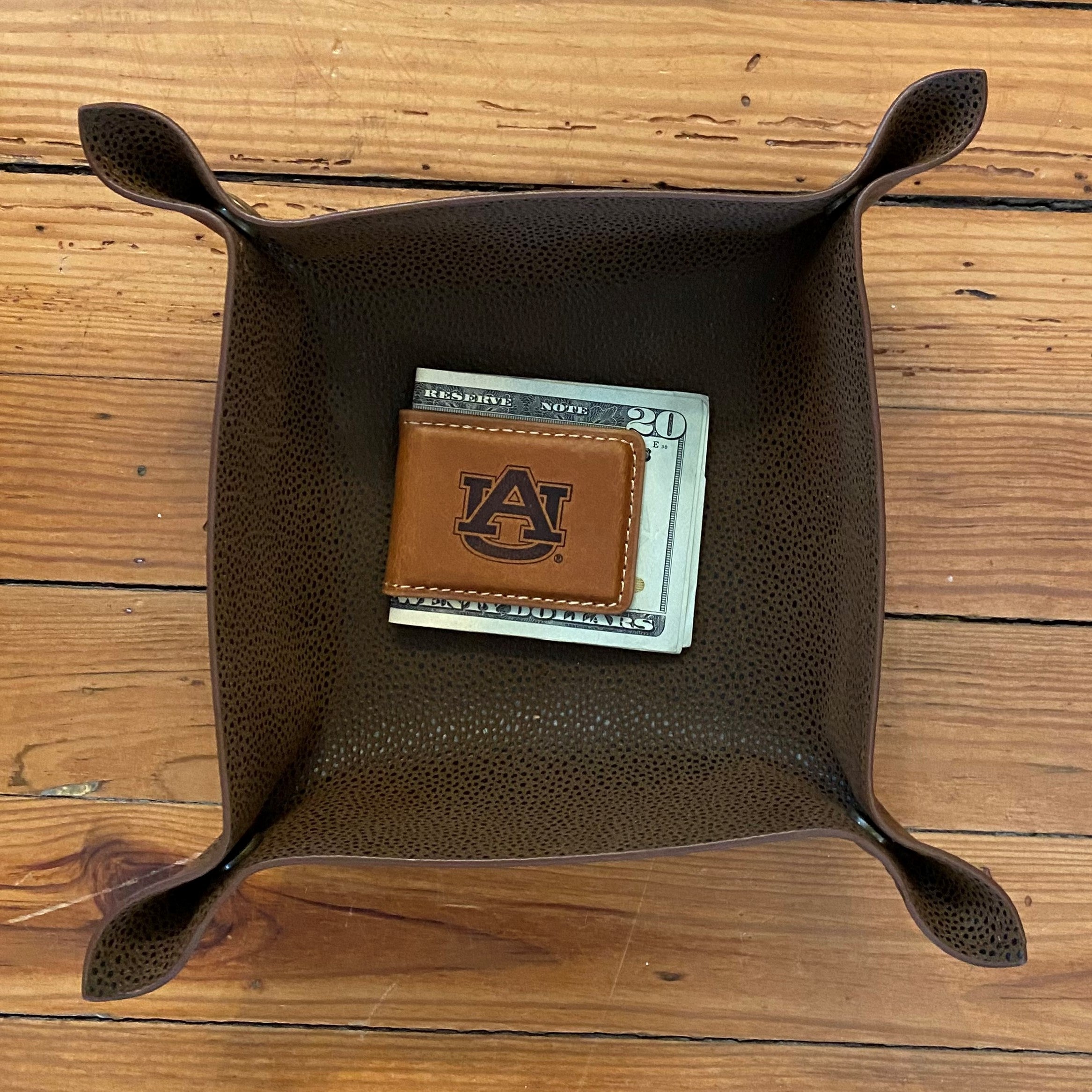 Keep track of your money while displaying your love for your college with this brown genuine leather magnetic money clip. Engraved graphic on top.