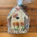 For the Spring season, these are absolutely the perfect gift for the bird lover or just the hard to shop for! These larger seed covered bird houses will thrill your feathered friends, and the nature lovers your life.   Hand decorated with natural raffia, floral, cranberries, raisins, and millet.  Under the seed and decoration is a small ornamental wooden bird house.  Approximately 11″ tall.  Comes wrapped in cellophane.