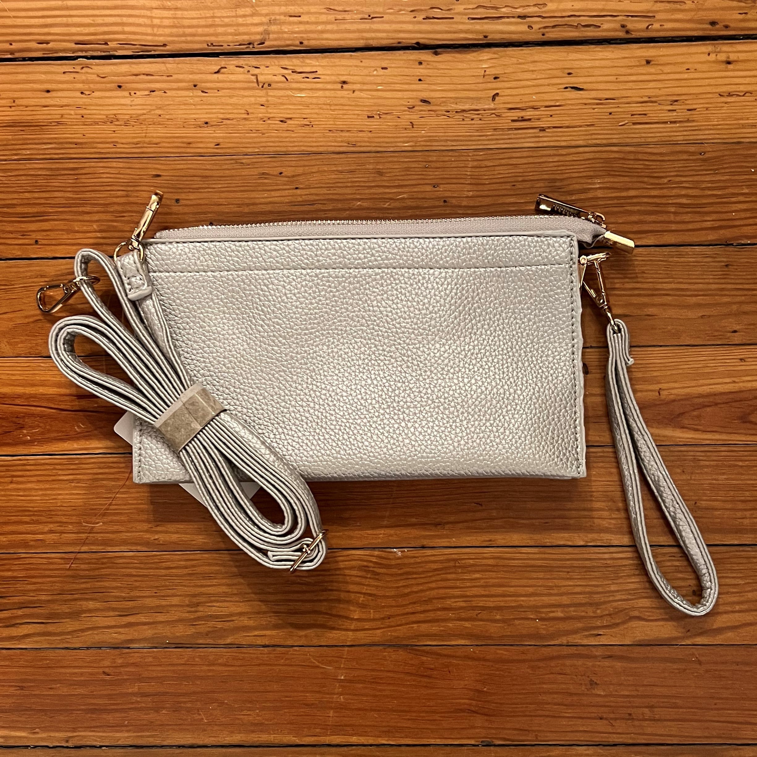 You will love this stylish silver bag! It can be used as a clutch, crossbody or wristlet - it's so versatile! It's such a nice neutral color that it can be dressy or casual. Such a nice piece!