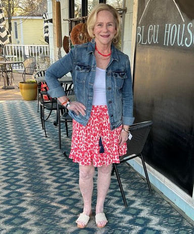 adorable floral print skirt with a white background and coral flowers is paired with a white tank and cute denim jacket. 