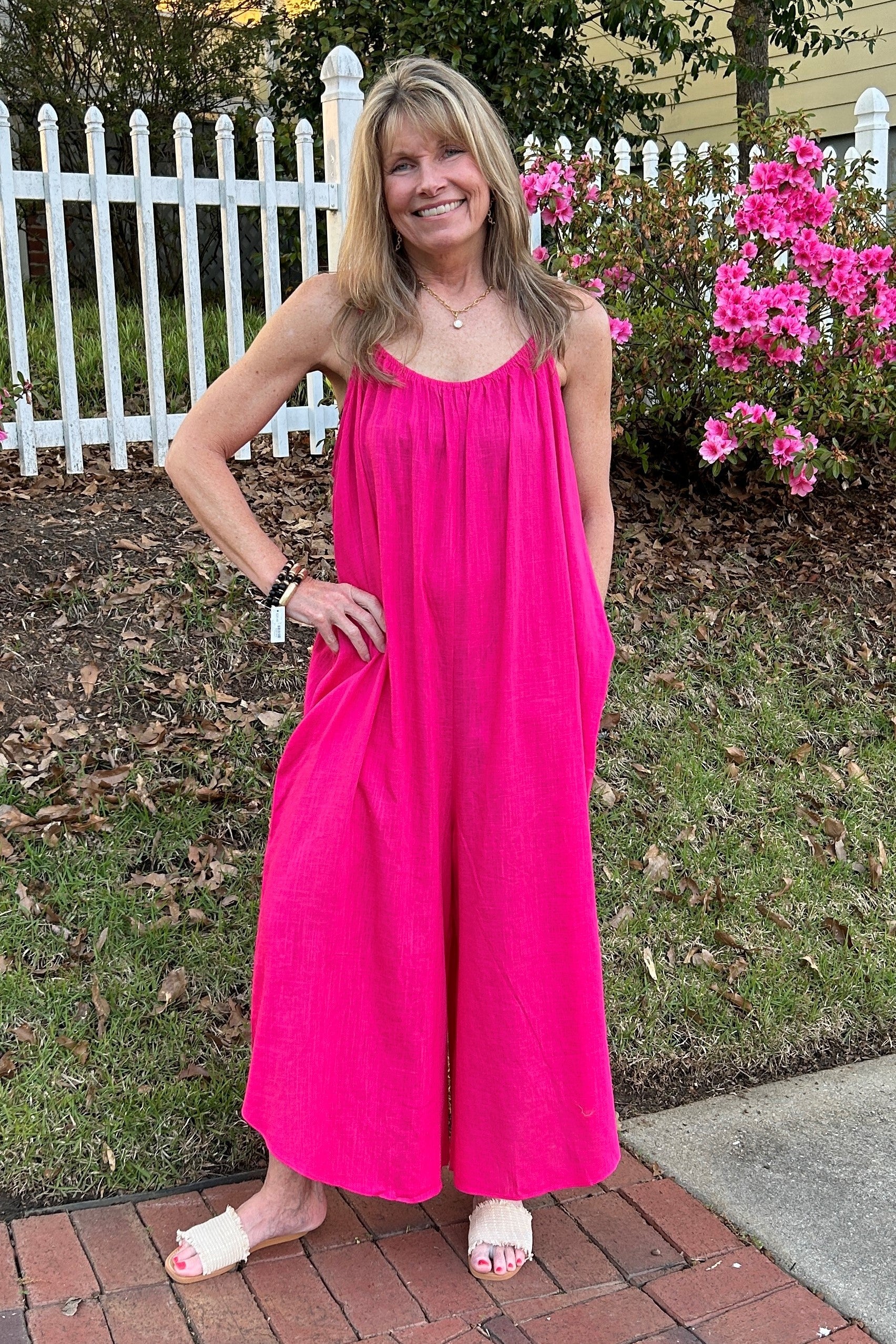 This hot pink spaghetti strap romper is the perfect way to show off your summer style. The top features an elastic neckline, side inset pockets and bottom romper to ensure a comfortable fit. Look and feel beautiful in this must-have piece.  Material: 70% Viscose / 30% Linen  Care Instructions: Hand wash cold, line dry, iron low heat