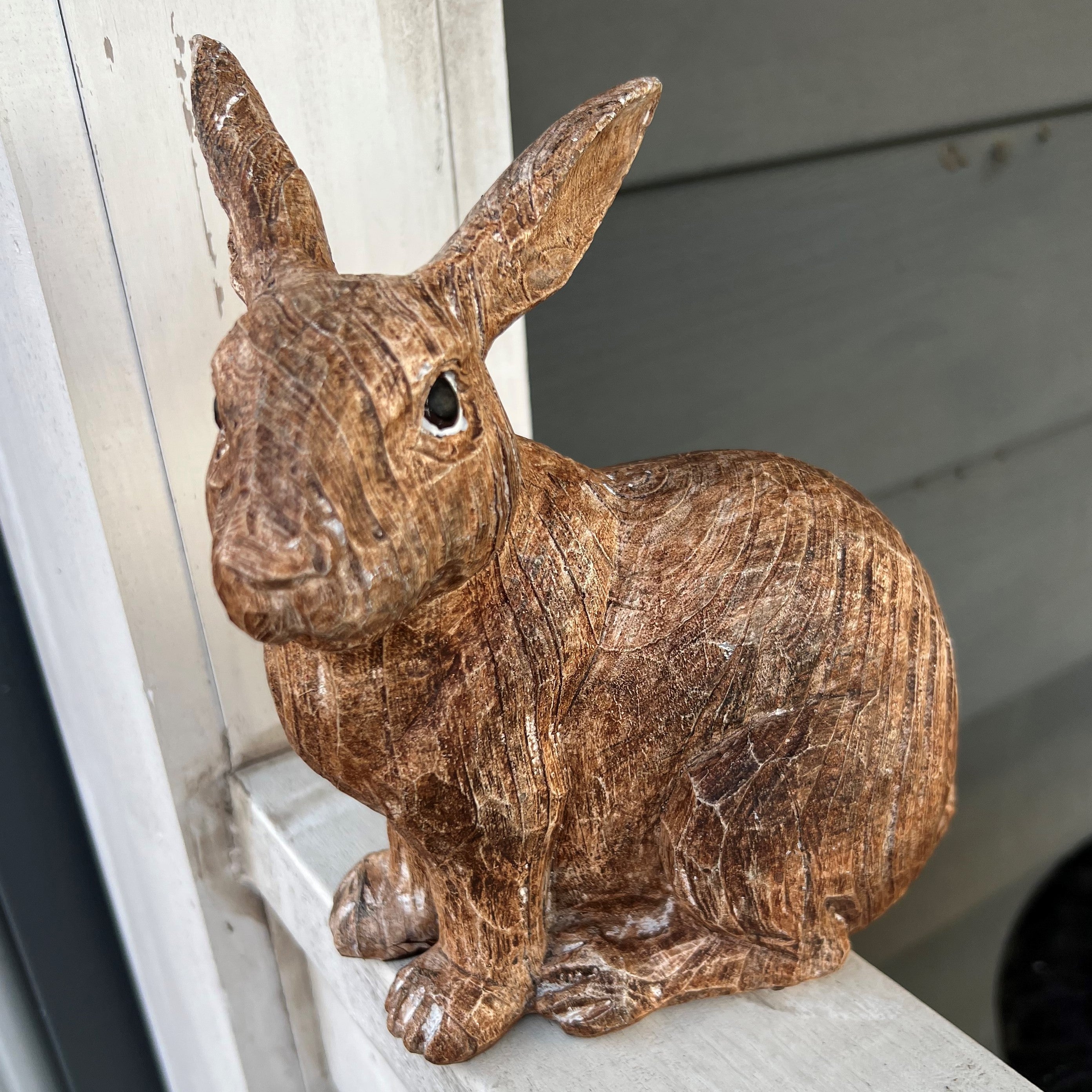 This is such a precious bunny that you will love to add to your home! It's a medium/natural brown color and is approximately 7.5" tall. It's made of resin with etched detailing.