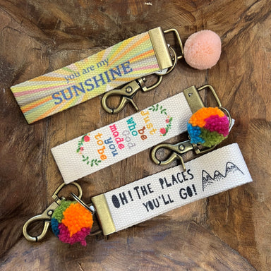 These are such fun and meaningful key chains. They have a canvas strap with a cute Pom Pom for decoration. The canvas strap has meaningful sentiments in fun colors!