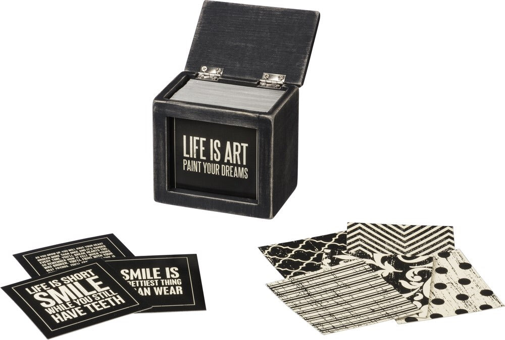 A black and white wooden hinged box with 80 double-sided inspirational sayings.