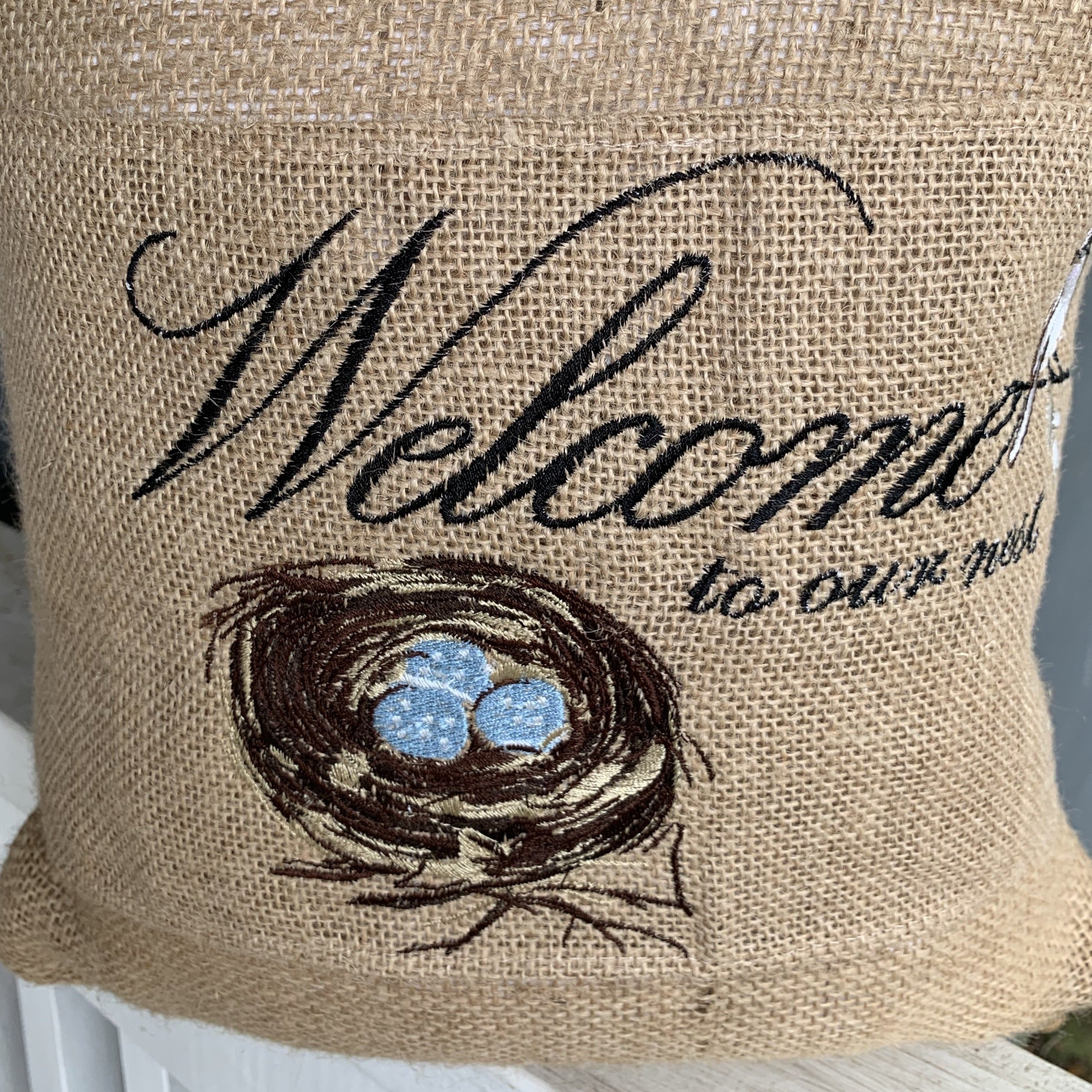 Embroidered Burlap Welcome to our Nest pillow wrap.
