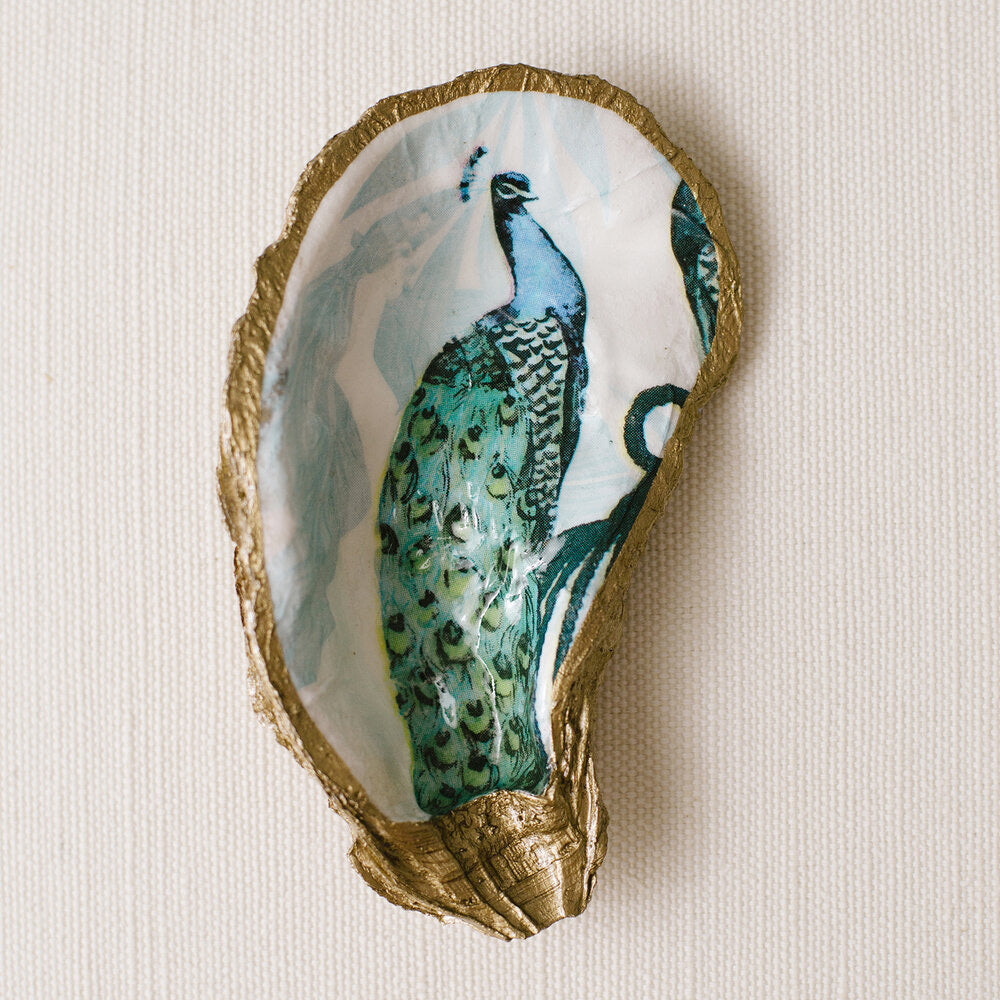 Grits and grace oyster shell painted with green and blue peacock