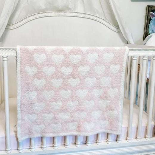 Pink blanket with white trim and white hearts