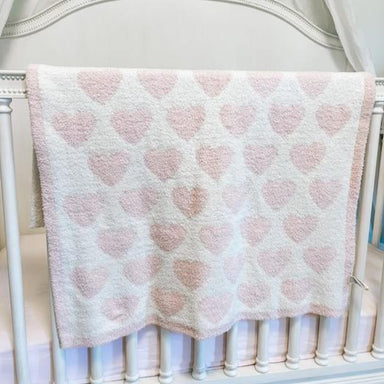 White blanket with pink trim and pink hearts throughout