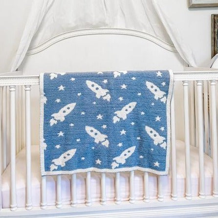 Blue blanket with a white trim and white stars and rockets throughout
