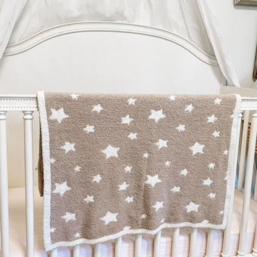 Tan blanket with white trim and white stars throughout